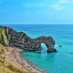 High angle view of people at durdle door against blue sky