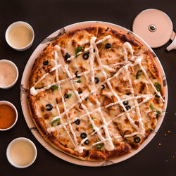 High angle view of pizza served on table