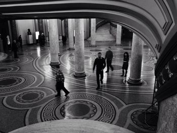 People walking in corridor of building