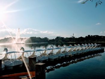 Boats moored in swimming pool against sky