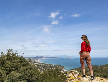 Man standing by sea against sky