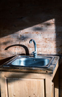 Close-up of old faucet in room