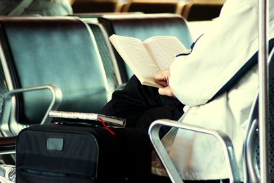 Rear view of man sitting on seat in bus