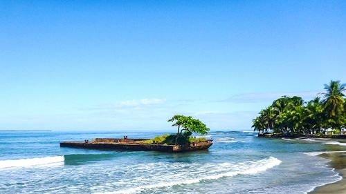 Scenic view of sea against clear blue sky