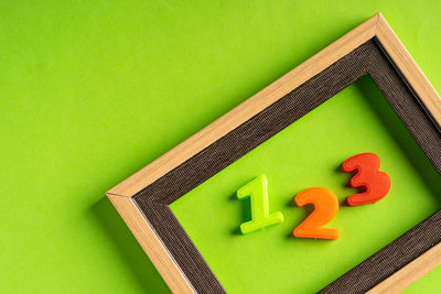 High angle view of toys against green background