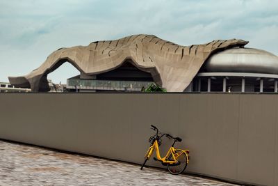 Bicycle parked against sky in city