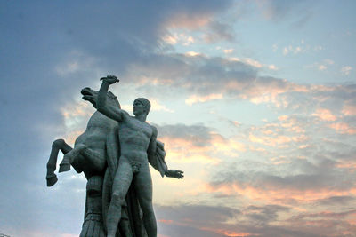 Low angle view of statue against sky during sunset