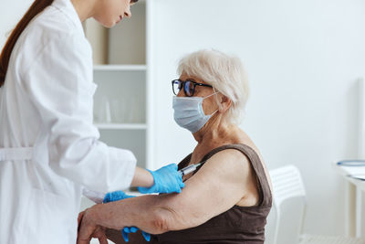 Midsection of woman wearing mask