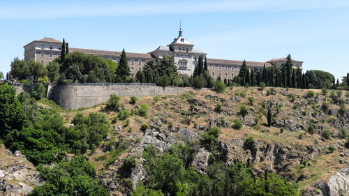 Panoramic view of trees and buildings against sky