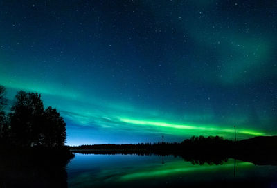 Scenic view of lake against sky at night