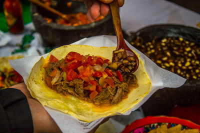 Close-up of hand holding a taco