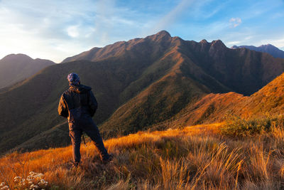 Man standing on mountain against sky