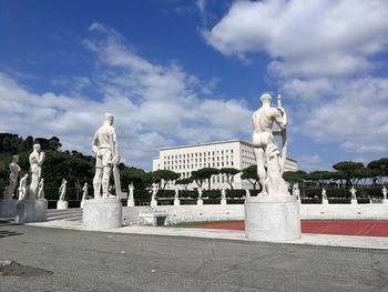 Statue of historic building against cloudy sky