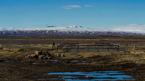 Scenic view of field against sky during winter