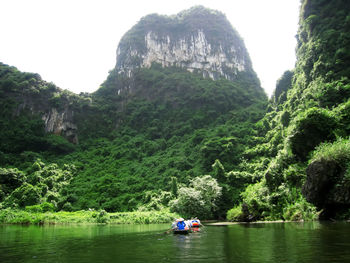 Scenic view of river amidst trees and mountains