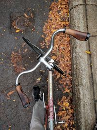 Rear view of man with bicycle on street