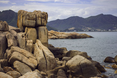 Scenic view of sea and mountains against sky