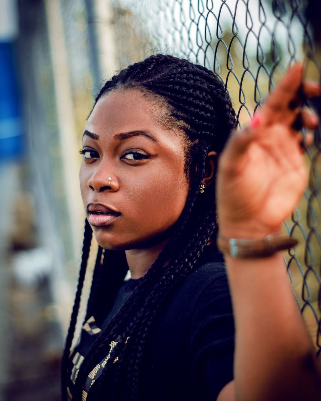 portrait, young adult, one person, real people, young women, lifestyles, headshot, leisure activity, looking at camera, selective focus, casual clothing, looking, standing, front view, black hair, fence, clothing, hairstyle, beautiful woman, contemplation