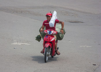 Woman riding motorcycle on road