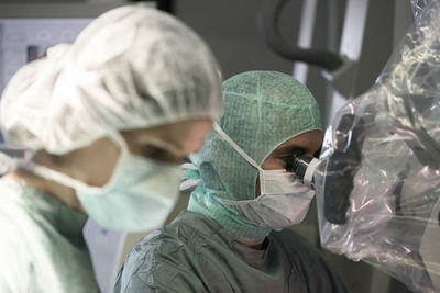 Neurosurgeon and operating room nurse during an operation