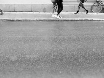 Low section of people walking on road