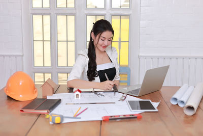 Young woman using laptop on table