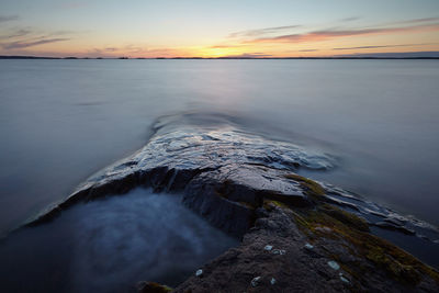 Scenic view of sea against sky at sunset