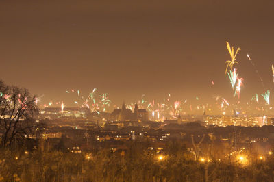 Firework display over city at night