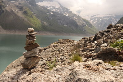 Scenic view of rock and mountains against sky