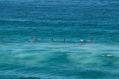 People swimming in sea