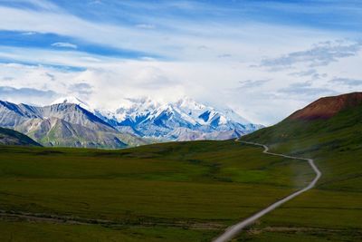 Scenic view of mountains against cloudy sky