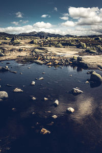 Aerial view of land and sea against sky