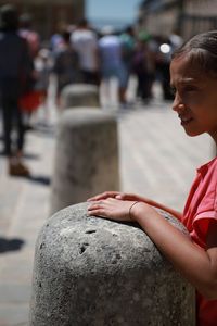 Boy looking at camera in city