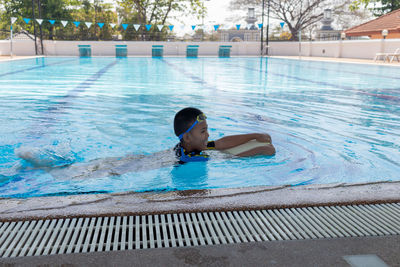 Boy swimming in pool
