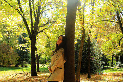 Man standing on tree trunk in park