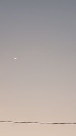 Low angle view of moon against clear sky at night