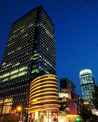 Low angle view of city lit up at night