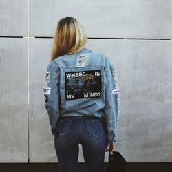 Rear view of woman standing against wall