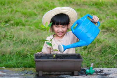 Cute boy watering plants