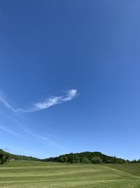 Scenic view of landscape against blue sky