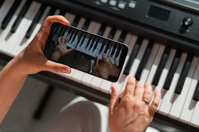 Cropped hand of woman using sound mixer