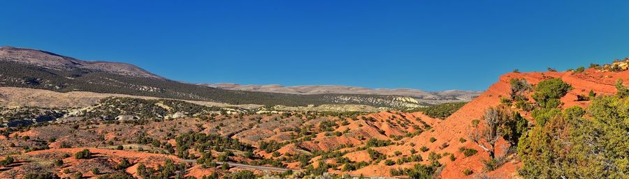 Scenic view of mountains against clear blue sky