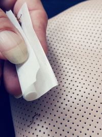 Close-up of woman holding cigarette on table