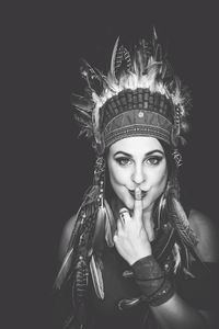 Portrait of woman against black background