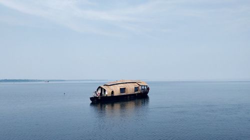 Boat sailing in sea against sky