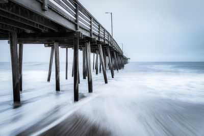 Pier over sea against sky