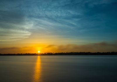 Scenic view of lake against sky during sunset