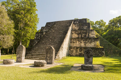 Stone structure at cemetery against sky