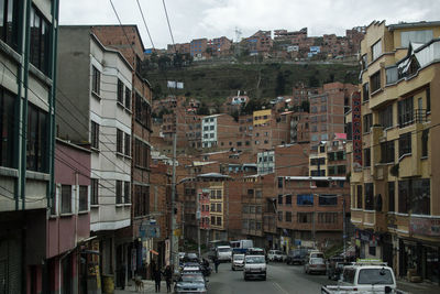 Vehicles on road by buildings in city