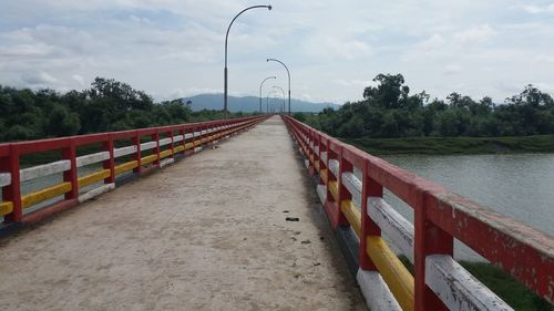 Street by river against sky